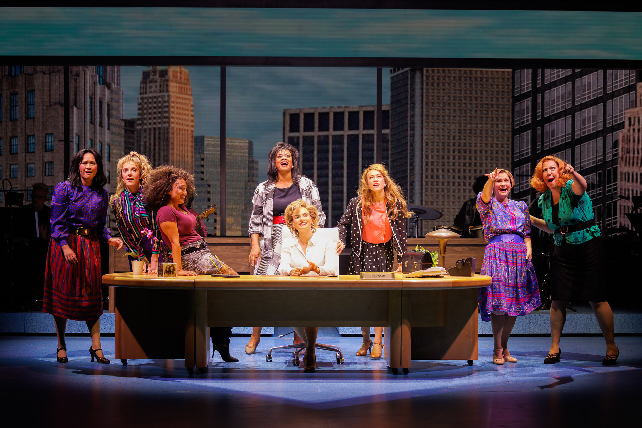 Joanna “JoJo” Levesque (center) with cast members in WORKING GIRL; photo by Rich Soublet II.